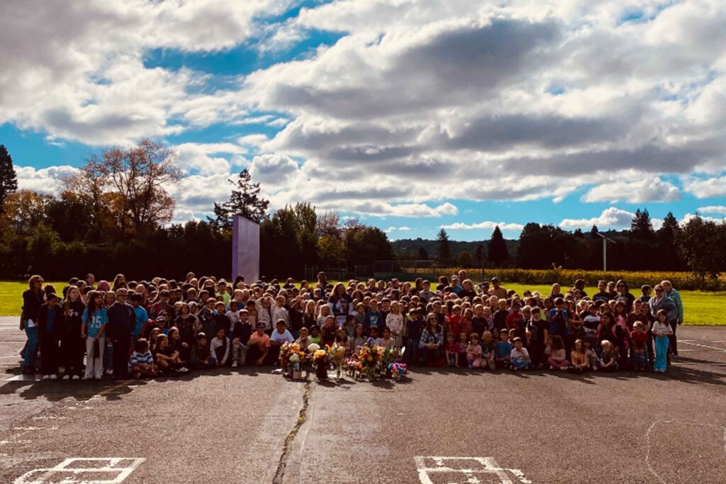 crowd of Vichy students surrounding Principal Zikmund on the blacktop